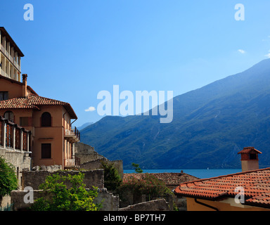 View over the red tiled rooftops to Lake Garda in Limone Sul Garda in Brescia, Italy Stock Photo