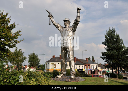 The Brownhills Miner designed and sculpted by John Mckenna and installed on a traffic island at a busy roads intersection Stock Photo