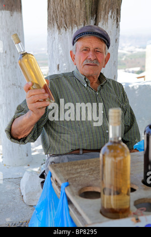 elderly man selling home made wine at the mountain village Pirgos, Santorini Island, Cyclades, Aegean Islands, Greece Stock Photo