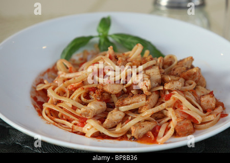 plate of linguine with chicken and tomato sauce Stock Photo