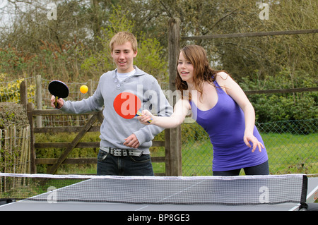 Young teenagers boy and girl playing table tennis Stock Photo