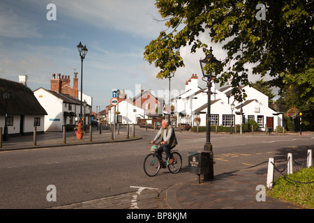 UK, England, Merseyside, Southport, Churchtown, man cycling along Botanic Road Stock Photo