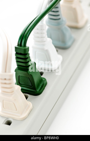 Many plugs plugged into electric power bar Stock Photo