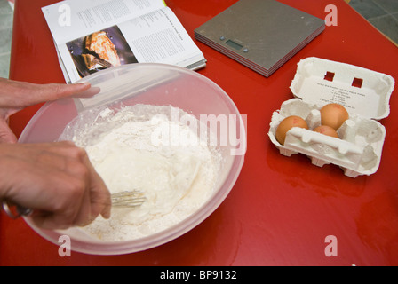 Mixing ingredients in a plastic bowl Stock Photo