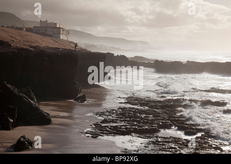 Plage Aglou coastline with distant fisherman, near Tiznit, Atlantic Coast, Morocco Stock Photo