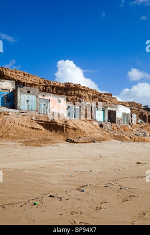 Plage Aglou with Fishermens' houses set into the cliff, Tiznit, Atlantic Coast, Southern Morocco Stock Photo