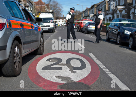 Police close a road with a 20 mile per hour limit after an accident. Stock Photo