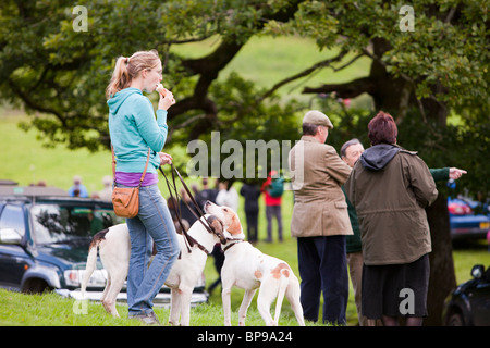 A woman with her hounds wating for the start of the hound trail at the Vale of Rydal Sheepdog Trials, Ambleside, Stock Photo