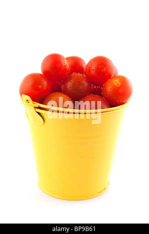 Yellow bucket full with fresh cherry tomatoes Stock Photo