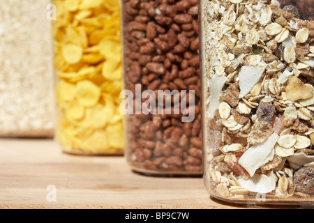 containers of different breakfast cereals including cornflakes coco pops chocolate rice muesli and oats Stock Photo