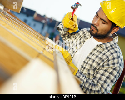 latin construction worker with hammer Stock Photo