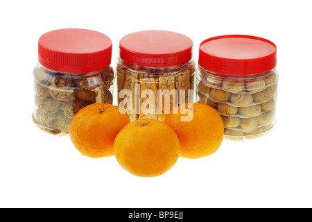 Chinese new year almond and peanut cookies with mandarin oranges on white Stock Photo
