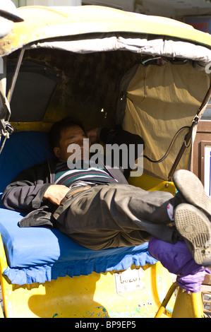 China, Suzhou. Rickshaw driver sleeping Stock Photo