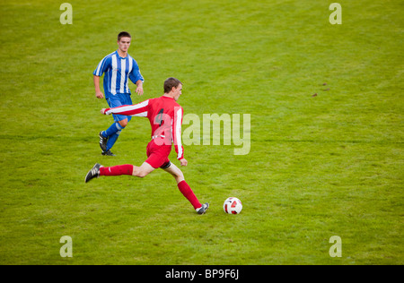 Ambleside FC playing Ulverston Town football club at Ambleside's football pitch, Lake District, UK. Stock Photo