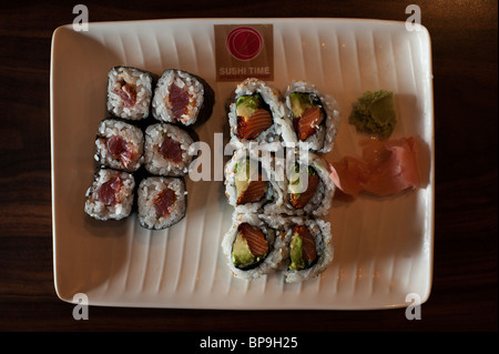 A spicy tuna roll and an inside-out roll of avocado and salmon share a plate at the 'Sushi Time' restaurant in Toronto. Stock Photo