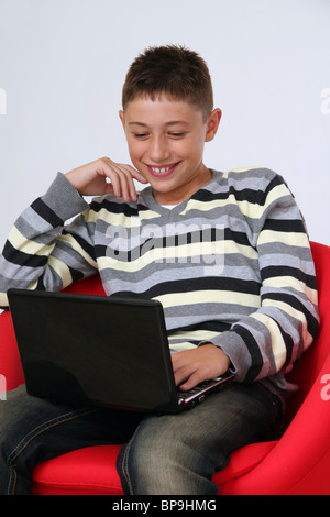Adolescent boy using a notebook computer Stock Photo