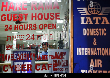 A man sits behind a counter at one of the guest houses in the Pahar Ganj  area where many budget hotels are located in Delhi. Stock Photo