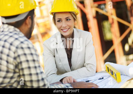 latin construction worker and female architect Stock Photo