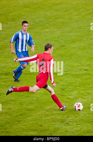 Ambleside FC playing Ulverston Town football club at Ambleside's football pitch, Lake District, UK. Stock Photo