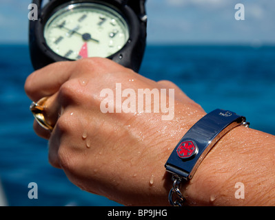 Medical bracelet on a scuba diver, indicative of diabetes. Stock Photo