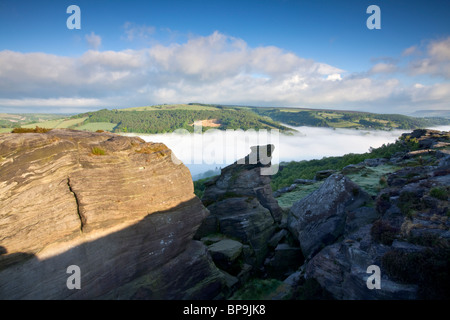 Froggatt edge at first light on May morning with mist filling the valley Stock Photo