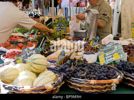 melons and grapes in a basket on a market stall in France, price in Euros Stock Photo