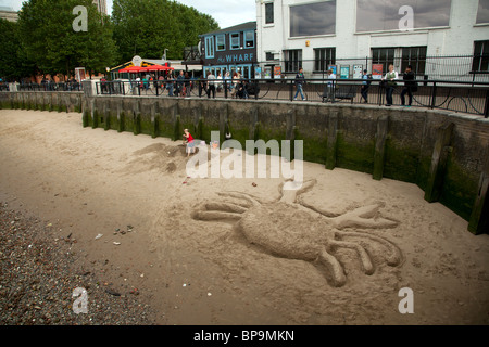 Crab sand sculpture on river Thames beach near Gabriel's Wharf, Southbank, London, England, UK. Stock Photo