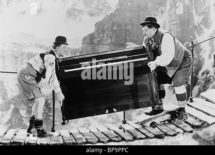 STAN LAUREL, OLIVER HARDY CARRY PIANO OVER MOUNTAIN, SWISS MISS, 1938 Stock Photo