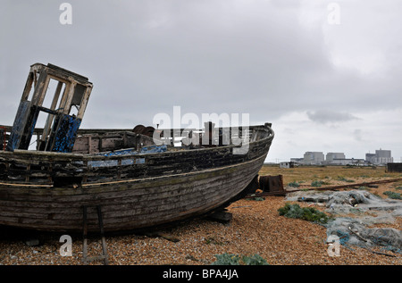 Old, abandoned fishing boat, Dungeness, Kent, England, UK. Nuclear Power Station in background. Stock Photo