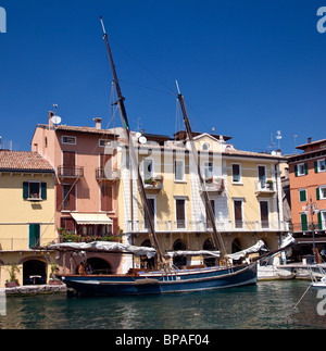 Sailing boat in the harbor of Malcesine on Lake Garda Stock Photo