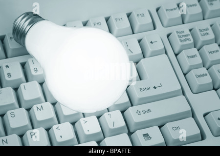 Light Bulb and Computer Keyboard close up shot Stock Photo