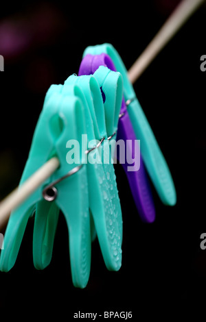 pegs on the washing line in the rain Stock Photo