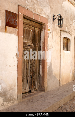 Old wooden door of a house in the 19th century mining town of Mineral de Pozos, Guanajuato state, Mexico Stock Photo
