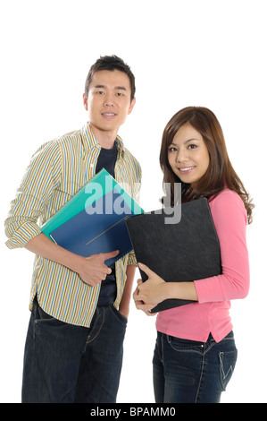 University students holding books and smiling in a classroom Stock ...