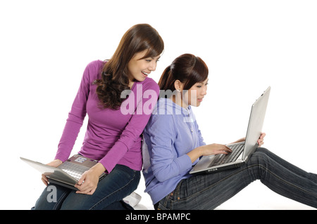 Two female university students working on laptops Stock Photo