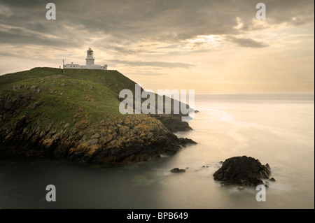 Strumble Head Lighthouse, Pembrokeshire, at sunset. Stock Photo