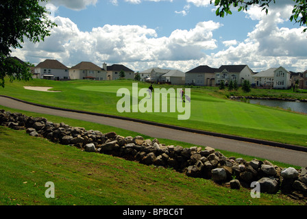 Golfers Walking On A Golf Course To The Putting Green Stock Photo