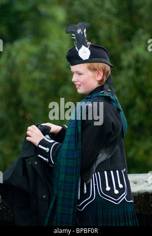 Scots girl with red hair and fair skin in traditional Scottish clothes. Stock Photo