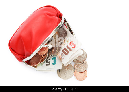 Isolated coin sterling money open red purse containing ten and five British pound notes GBP with some cash coins spilling out from above. England UK Stock Photo