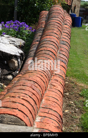 There are so many ways a garden wall can be built and so many different bricks, blocks and stone that can be used. Stock Photo