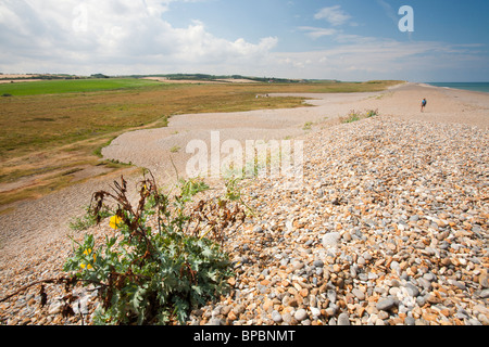 The storm beach at Cley breached by severe storms which will only increase with sea level rise. Stock Photo