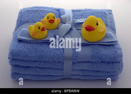 Rubber ducks on blue towels Stock Photo