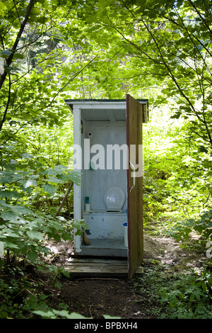 An outhouse / outdoor toilet in the woods Stock Photo