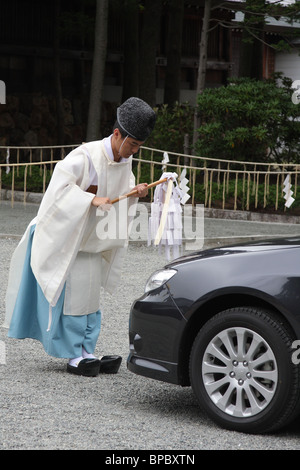 Japanese Shinto priest blessing a new car Stock Photo