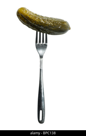 Large dill pickle on a fork isolated silhouette with a clipping path on white background Stock Photo