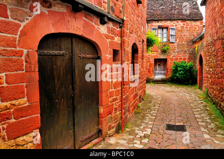 France: Alley and red sandstone houses in medieval village Collonges-la-Rouge Stock Photo