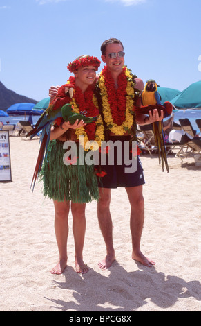 Couple posing for photographs, Waikiki Beach, Honolulu, Oahu, Hawaii, United States of America Stock Photo