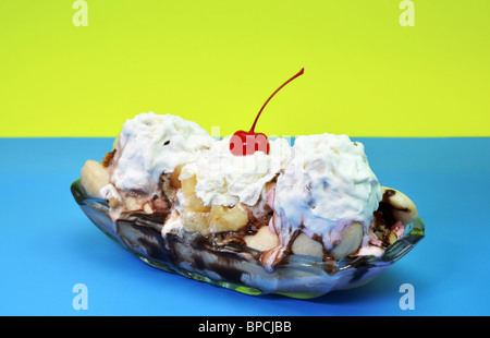 Banana split isolated on blue and yellow background. Stock Photo