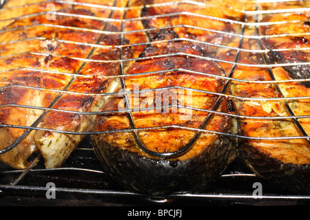 Salmon cooking on grill. Shallow DOF Stock Photo