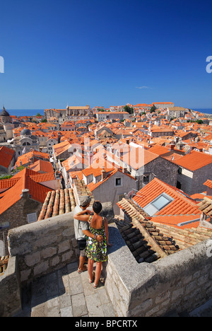 DUBROVNIK, CROATIA. A young couple looking out over the historic centre of old Dubrovnik from the city walls. 2010. Stock Photo